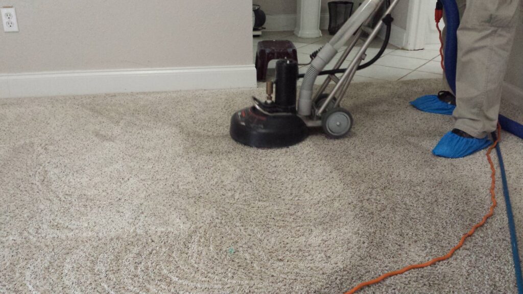 The carpet cleaning process in a home, showing a machine cleaning a carpet by Sparky Carpet Cleaning in Baton Rouge, LA.