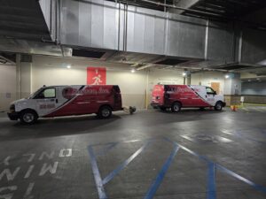 A professional carpet cleaning process in action, showing the extraction hose used by Raysco, Inc. in Las Vegas, NV.