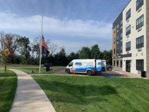 Carpet Cleaning Pros LLC service van parked outside a building with hoses, ready for a job in Eau Claire, WI.