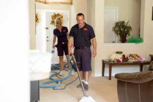 Two technicians performing a professional carpet cleaning service at a home by Everything Under The Son Carpet Cleaning in Orlando, FL