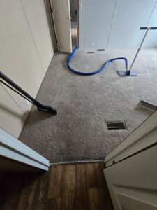 A professional carpet cleaning service being performed in a hallway by CleanWater Restoration in Edmond, OK.