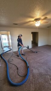 A technician performing a carpet cleaning service with professional equipment at Jake's Steamer the Carpet Cleaner in Seminole, TX