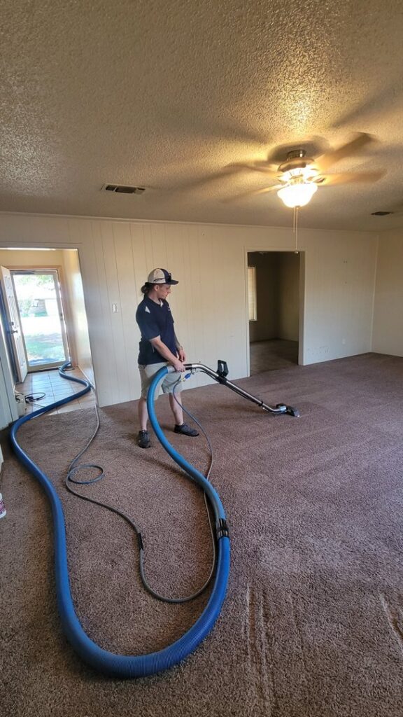 A technician performing a carpet cleaning service with professional equipment at Jake's Steamer the Carpet Cleaner in Seminole, TX