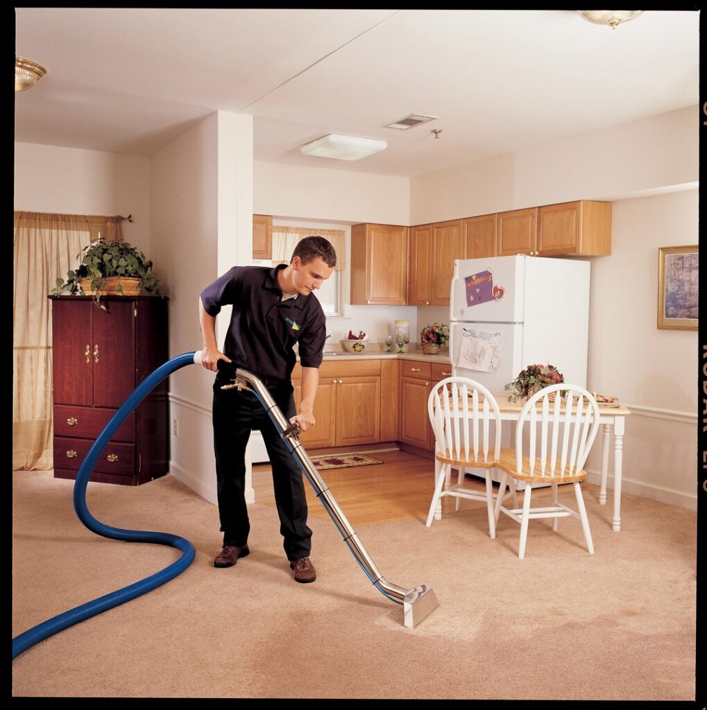 A ServiceMaster by Wright technician cleaning a carpet in a home in San Antonio, TX