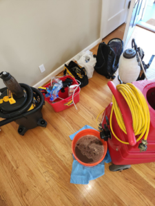 Carpet cleaning equipment and dirty water after a job by Flawless Cleaning Everything in Wilsonville, OR.