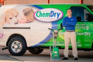 A carpet cleaning specialist standing proudly with a Chem-Dry van and cleaning equipment for Mountainview Chem-Dry in Birmingham, AL.