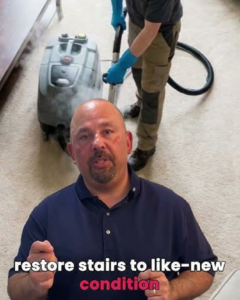 A professional from AJS Carpet Cleaning, Inc. cleaning carpeted stairs with a steam cleaner in Orem, UT.