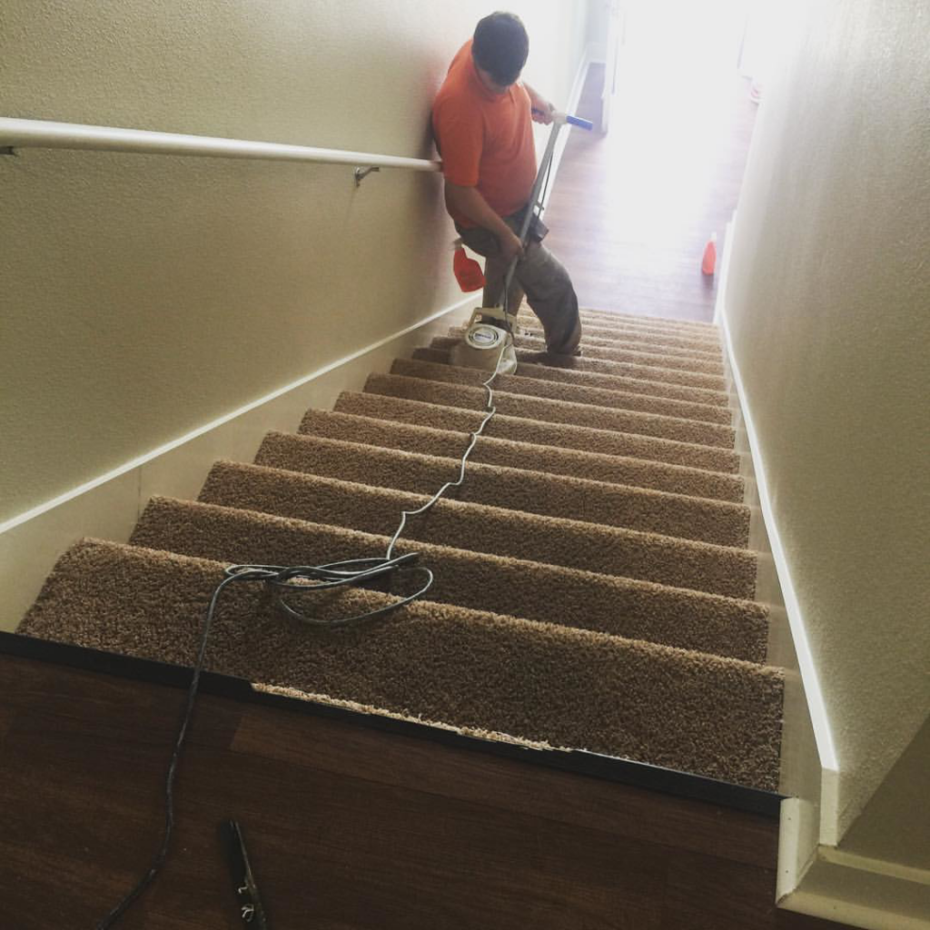 A Carpet Anew LLC contractor cleaning carpeted stairs in Gladstone, MO.