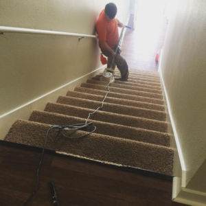 A Carpet Anew LLC contractor cleaning carpeted stairs in Gladstone, MO.