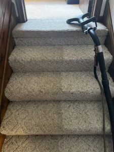 A professional carpet cleaning tool being used on carpeted stairs by PRIME CLEAN VA in Virginia Beach, VA.