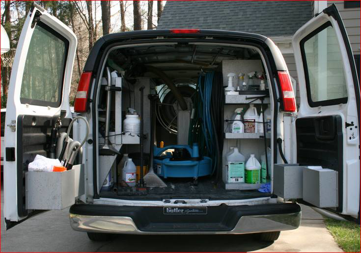 The back of a service van loaded with professional carpet cleaning supplies and equipment for stpaulbestcarpetcleaners.com in Saint Paul, MN.