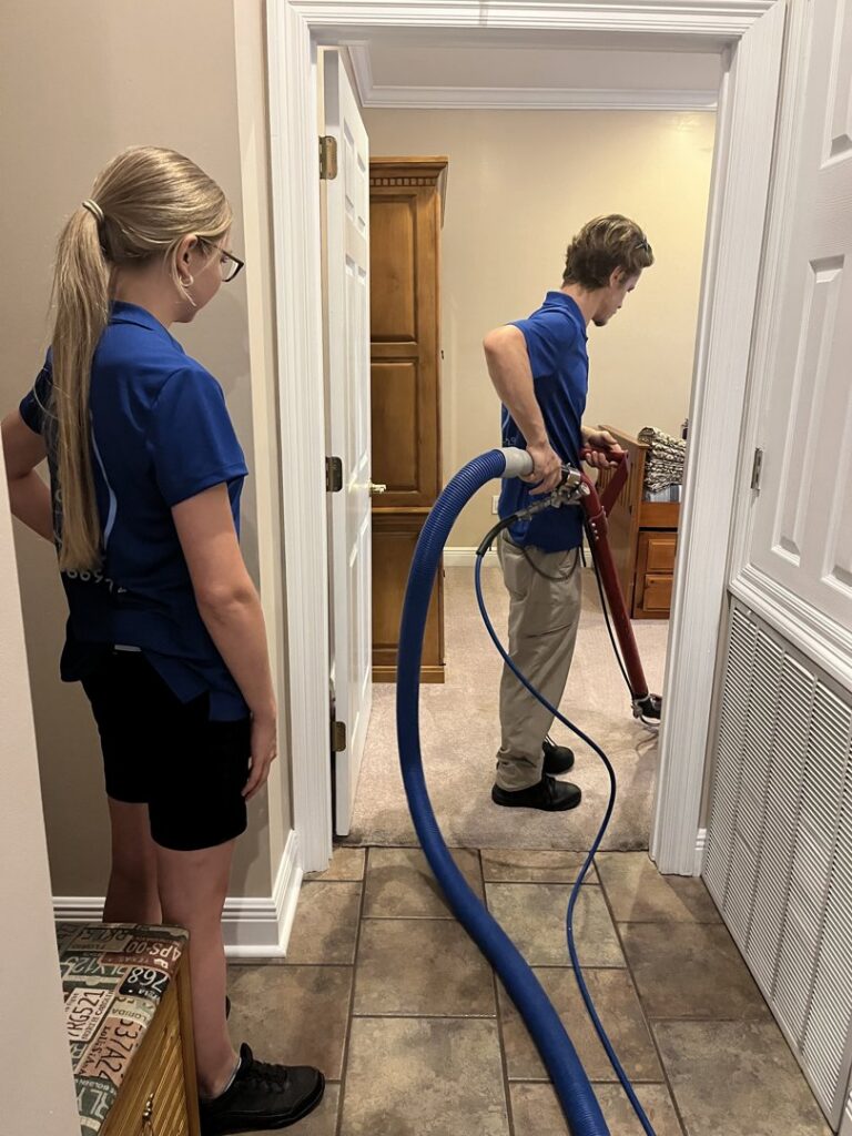 A Carpet Chemistry team member performing professional carpet cleaning in a home in Gulfport, MS.