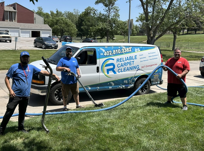 The Reliable Carpet Cleaning LLC team with their equipment and branded van, ready for work in Liverpool, NY.