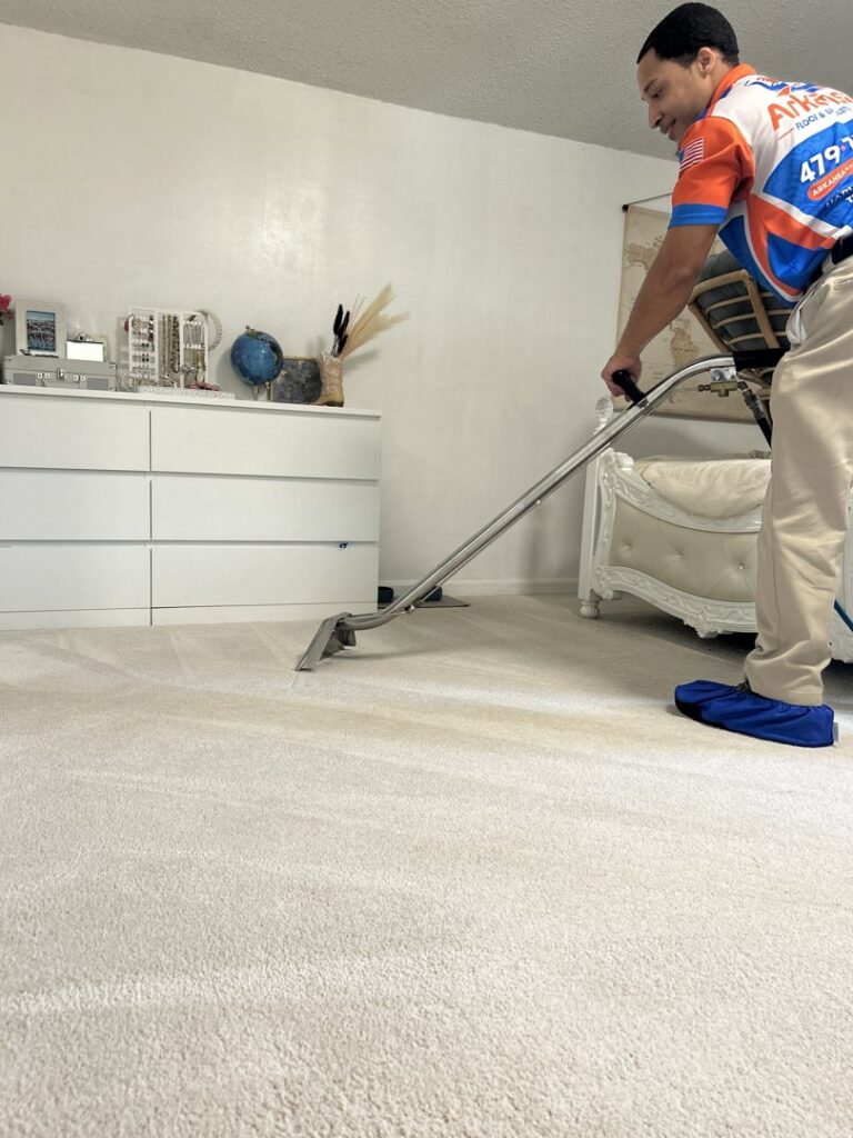 A carpet cleaning technician from Arkansas Floor and Upholstery Care LLC cleaning an installed carpet in Fort Smith, AR.