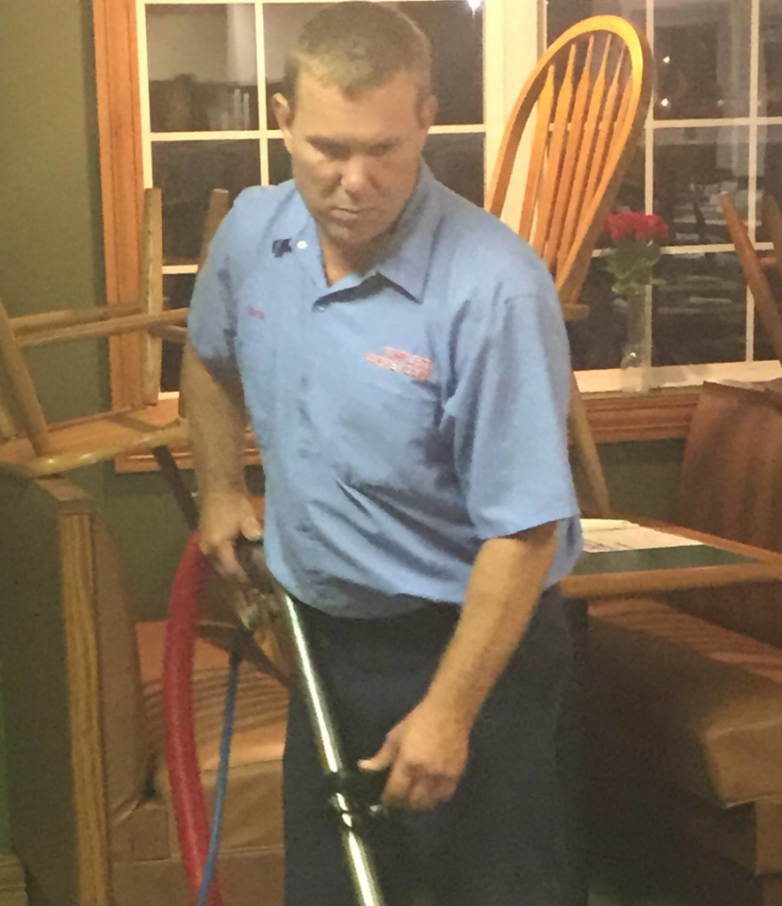 A carpet cleaning technician from Complete Carpet Care at work, cleaning a carpet in Fort Wayne, IN.
