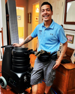 A SAENZ Carpet Cleaning technician standing proudly with professional cleaning equipment in Dallas, TX.