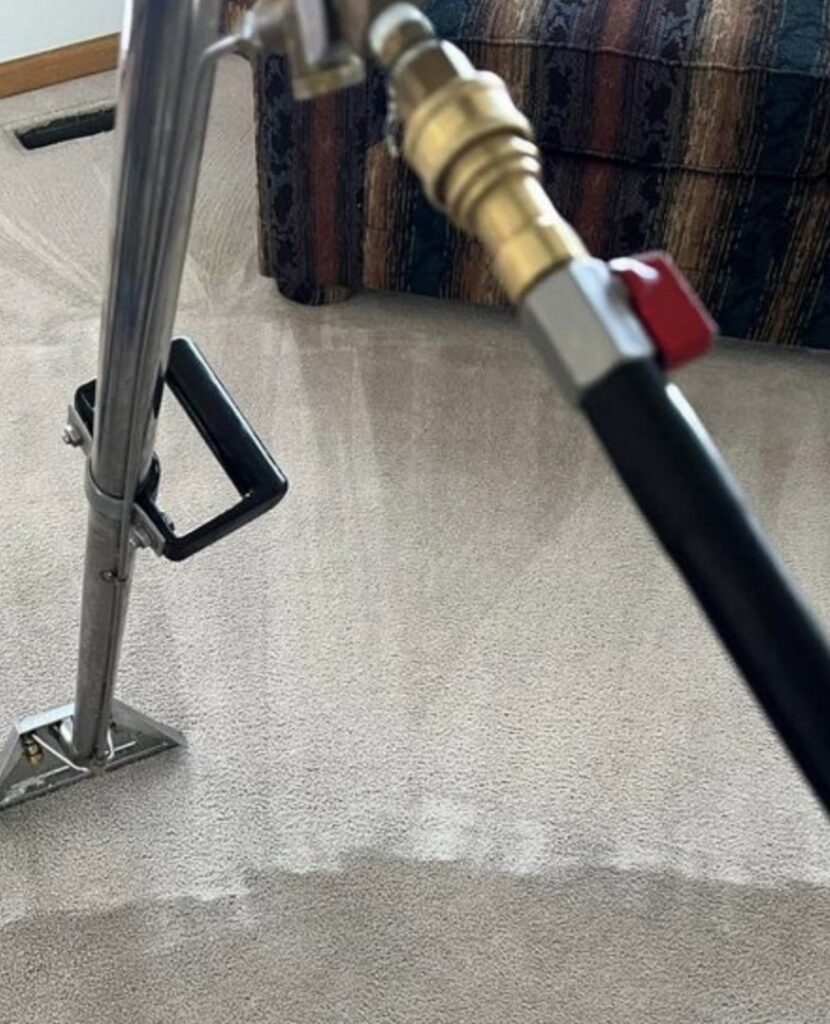 Close-up of a carpet cleaning tool in action on a light-colored carpet by Done Right Carpet Cleaning Omaha, NE.