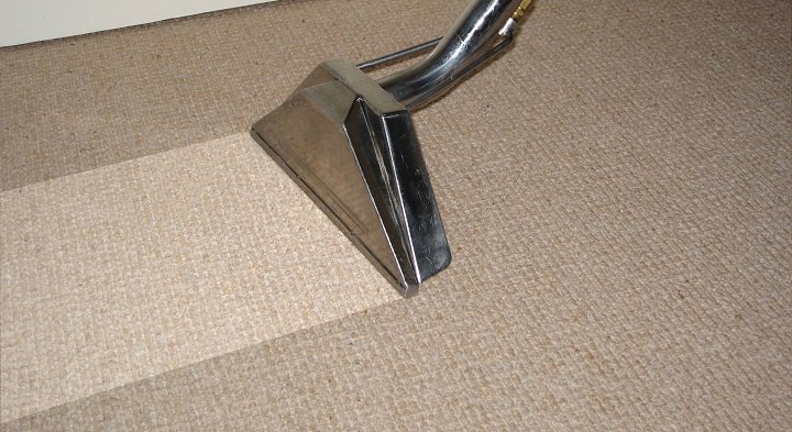 A carpet cleaning tool in action, showing a clean path on a carpet by Duraclean by Barton in Independence, MO.