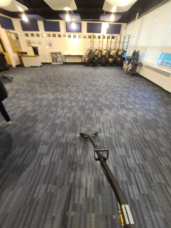 A professional carpet cleaning tool being used on a blue patterned carpet by B&H Property Maintenance LLC in Middletown, CT.