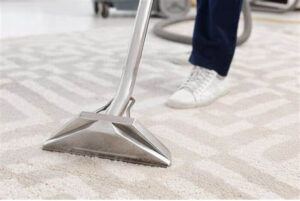 A carpet cleaning tool in use on a light patterned carpet by Premier Carpet Cleaning in Colorado Springs, CO.