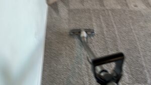 A carpet cleaning tool in action, cleaning a room's carpet by KD Carpet Cleaning in Albuquerque, NM.