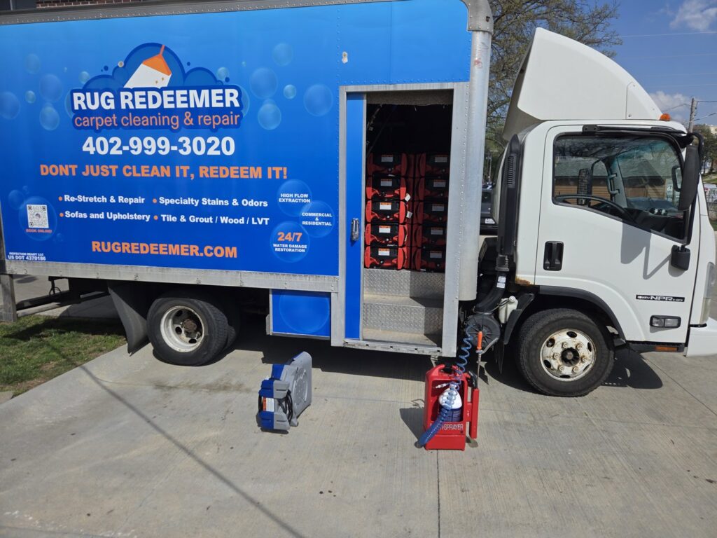 A Rug Redeemer carpet cleaning truck with hoses and equipment set up for a job by Inspection Ready LLC in Bellevue, NE.