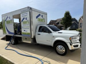 Trent's Carpet Cleaning & Restoration truck with hoses extended, ready for a professional cleaning job in Fishers, IN.