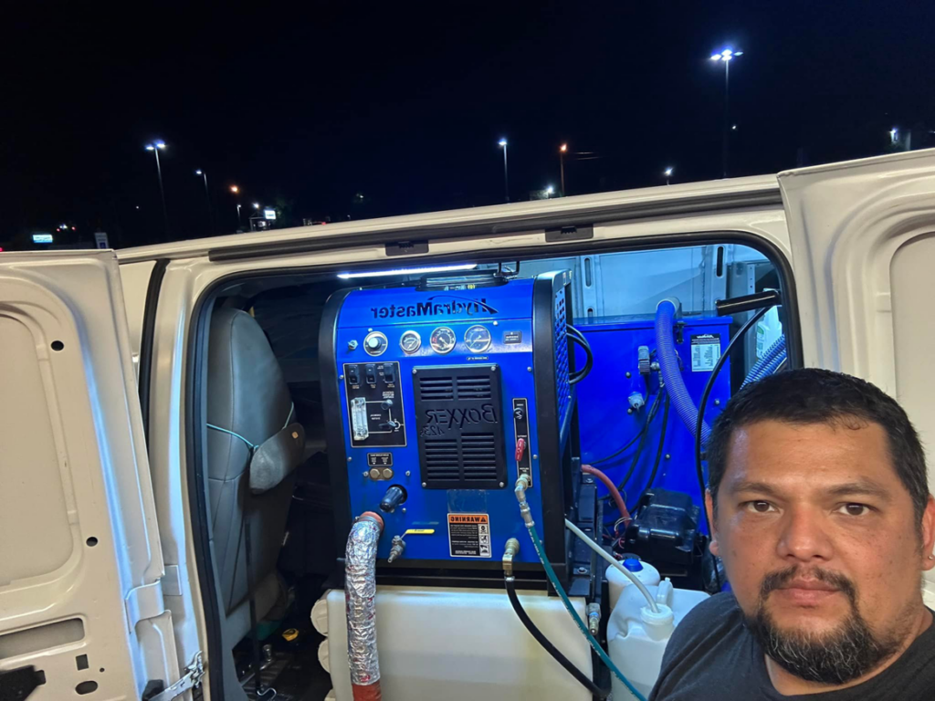 A carpet cleaning technician with truck-mounted equipment for Evolution Clean Care in Knoxville, TN