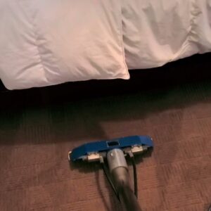 A professional carpet cleaning tool being used to clean carpet under a bed by Belles Carpet Cleaning & Janitorial Inc. in Harrisburg, PA.