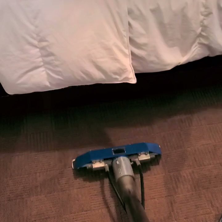 A professional carpet cleaning tool being used to clean carpet under a bed by Belles Carpet Cleaning & Janitorial Inc. in Harrisburg, PA.