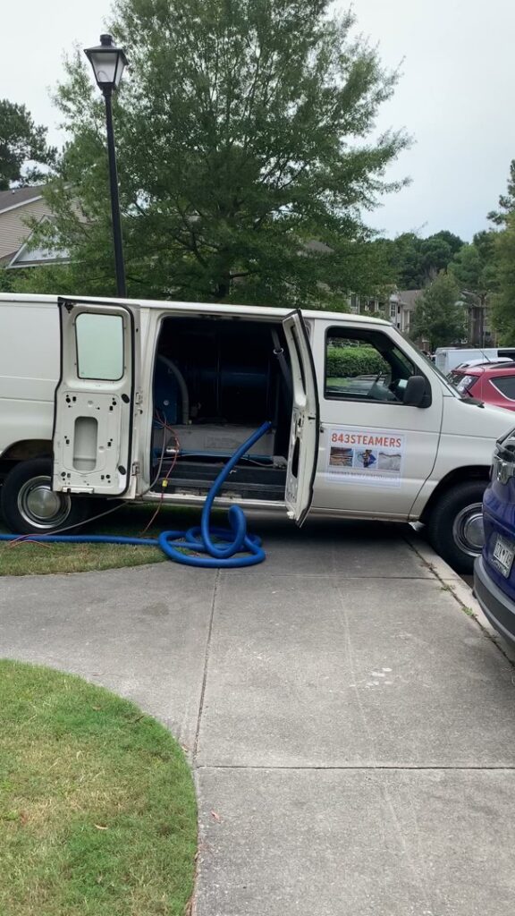 A professional carpet cleaning van with hoses ready for a job by 843Steamers in Summerville, SC.