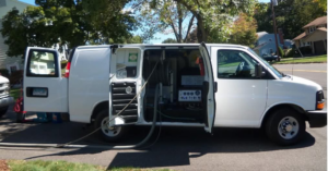 A white service van with carpet cleaning equipment and hoses ready for a job by Glory Carpet Cleaning Service in East Hartford, CT.
