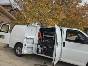 A KD Carpet Cleaning service van with professional cleaning equipment visible, ready for jobs in Albuquerque, NM.