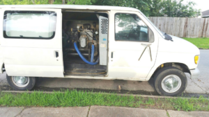 A Kustom Carpet Kare service van with professional carpet cleaning equipment visible inside in Houston, TX