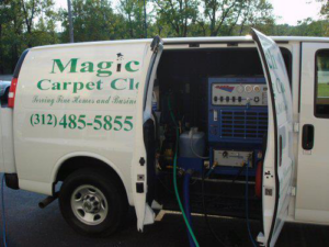 A Magic Touch Carpet Cleaning van with open doors revealing professional carpet cleaning equipment and hoses in Chicago, IL.