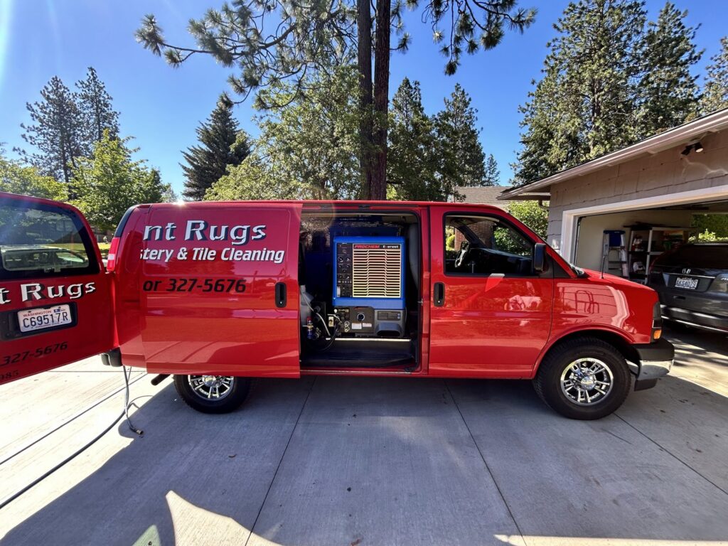 Radiant Rugs Carpet Cleaning van with professional cleaning equipment visible inside, parked at a job site in Spokane, WA.