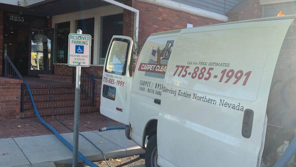 Eagle 1 Carpet Cleaning van with a hose running into a building for a carpet cleaning job in Reno, NV.