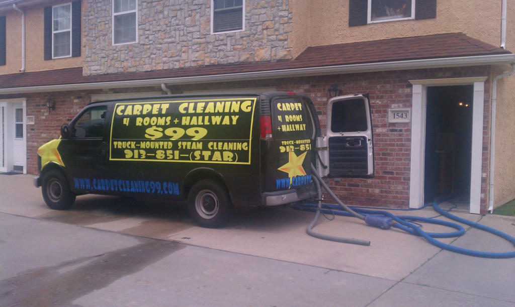 Carpet cleaning van with hoses extended into a building at a job site by Celebrity Carpet and Upholstery Cleaning, Overland Park, KS.