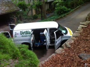 A Dirt Blasters Carpet Cleaning Inc. van with doors open and hoses extended for a job at a residential site in Atlanta, GA