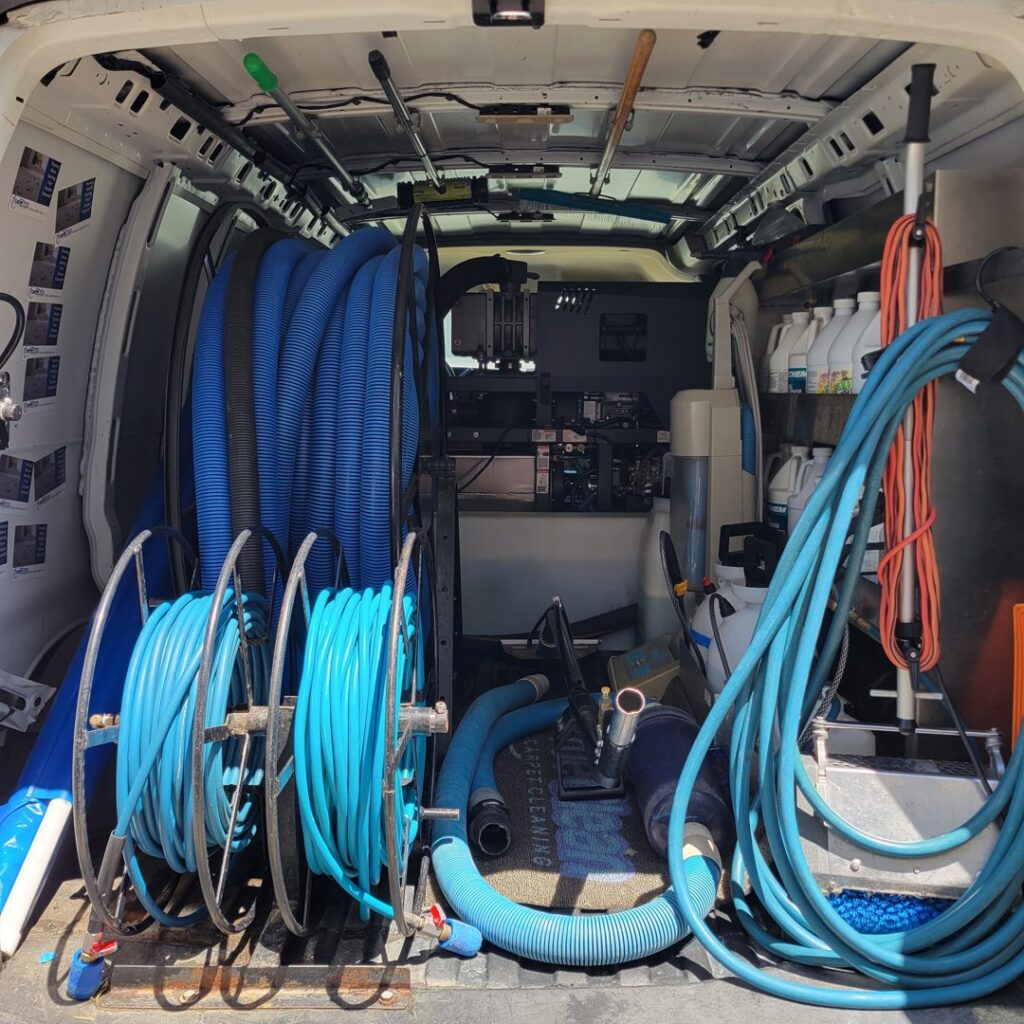 Interior of a True Organic Carpet Cleaning van showing hoses and professional equipment in Charlotte, NC.