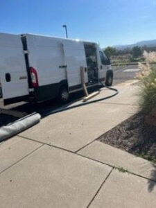 A Precise Carpet Care service van with equipment and a rolled carpet, ready for a job in Albuquerque, NM.