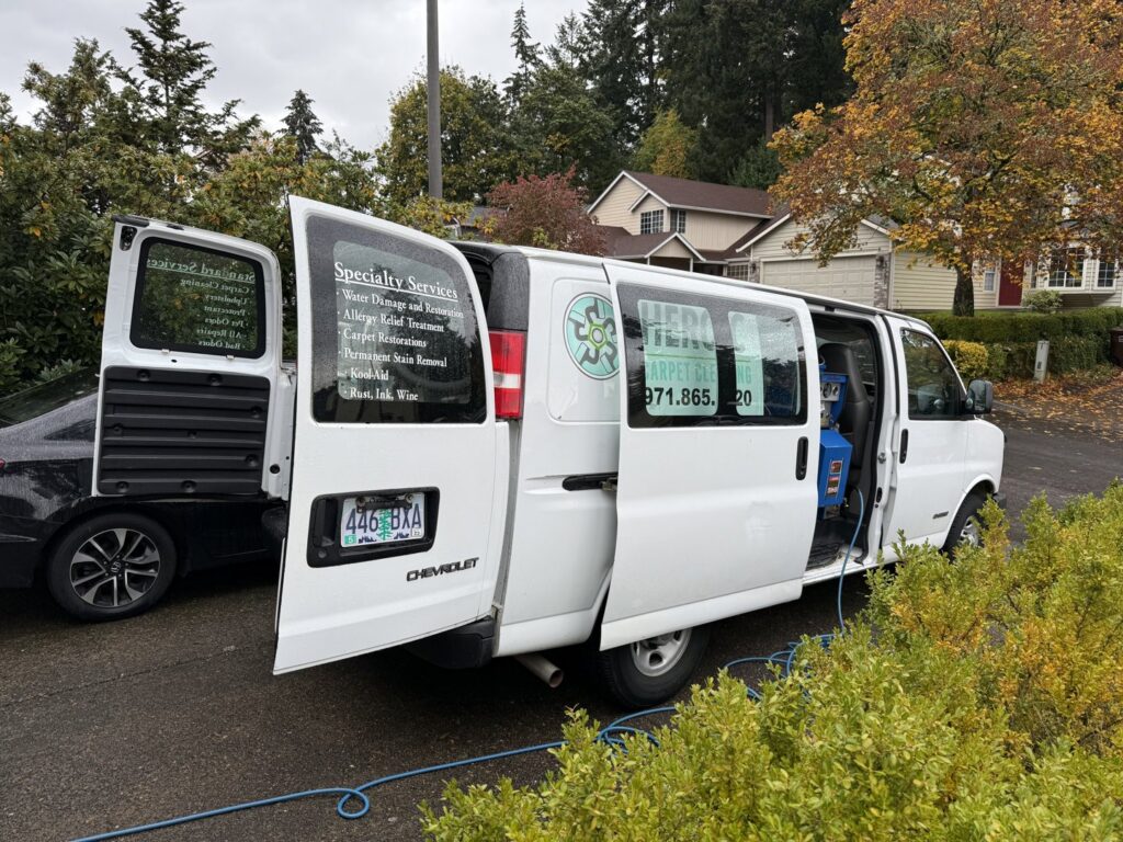 A Heroic Carpet Cleaning Oregon van with its doors open, revealing professional cleaning equipment and hoses ready for a job in Beaverton, OR