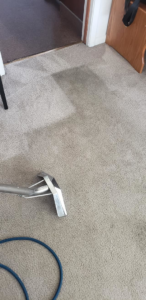 A carpet cleaning wand and hoses on a residential carpet during a cleaning service by Vibro-Steam of Utah in Ogden, UT.