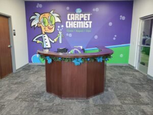 A professional carpet cleaning wand being used on a blue carpet by The Carpet Chemist in Louisville, KY.