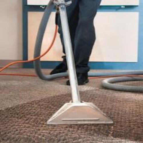 A close-up of a carpet cleaning wand in action on a brown carpet for First Choice Janitorial Services in Vancouver, WA.