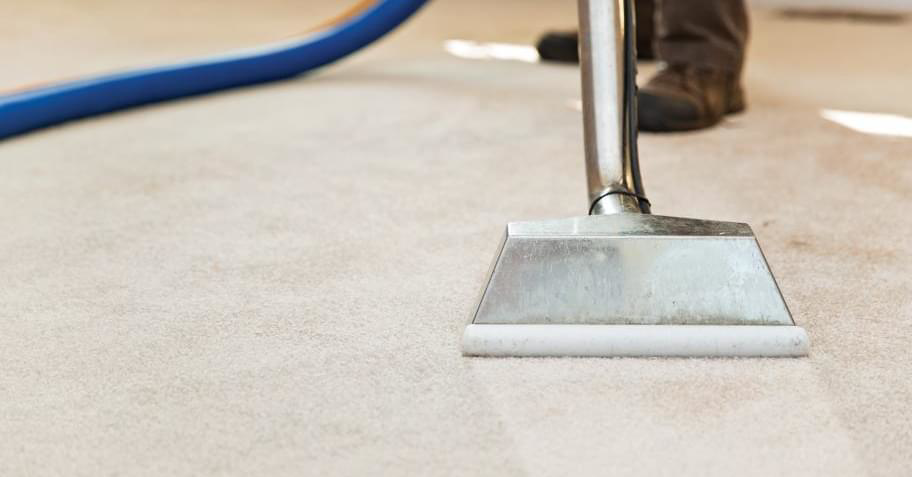 A carpet cleaning wand in action, showing a clean strip on a light-colored carpet by Achilles Carpet Cleaning in Vancouver, WA.