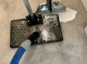 A carpet cleaning wand actively cleaning a carpet, showing suds and water extraction by Hi-Tech Carpet Cleaning in Elk Grove, CA.