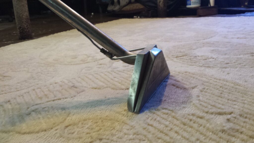 A professional carpet cleaning wand in action on a light-colored carpet, showcasing services by Carpet Cleaner Staten Island in Staten Island, NY.