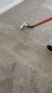 A professional carpet cleaning wand in action, deep cleaning a carpet by Carpet Cleaners Plus in Chicago, IL.