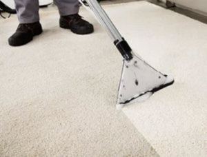 A professional carpet cleaning wand in action, showing a clean path on a light-colored carpet by Safe Solutions Carpet Cleaning in Franklin, TN.
